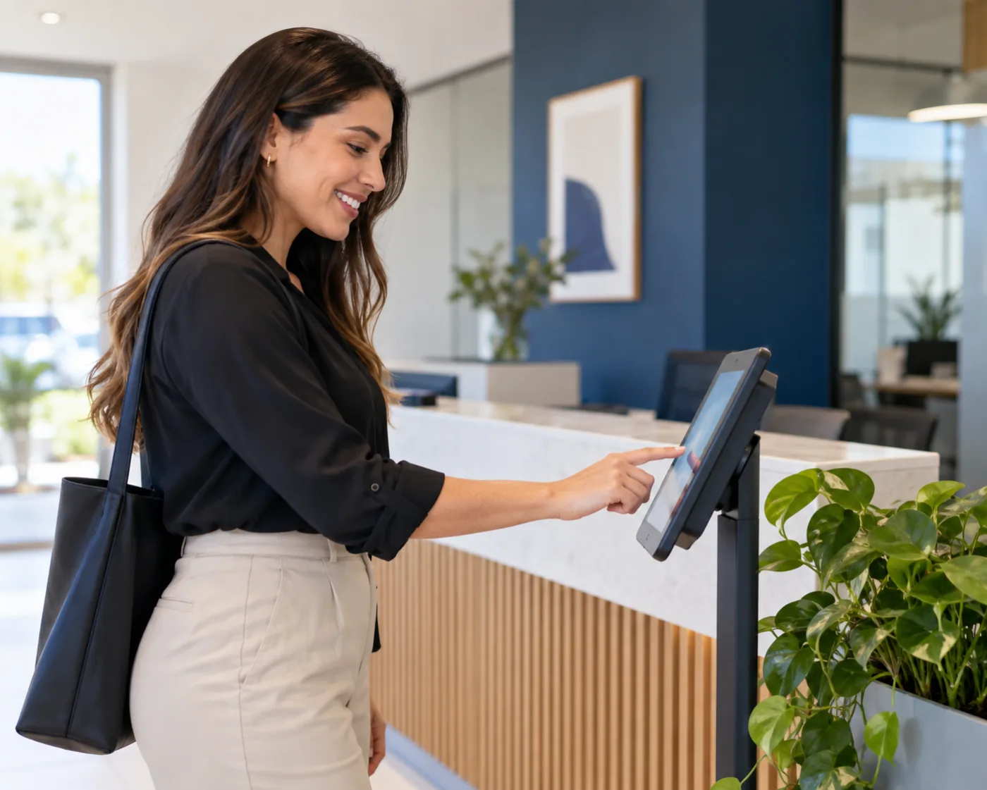 Empleada checando su entrada en una tablet en la recepción